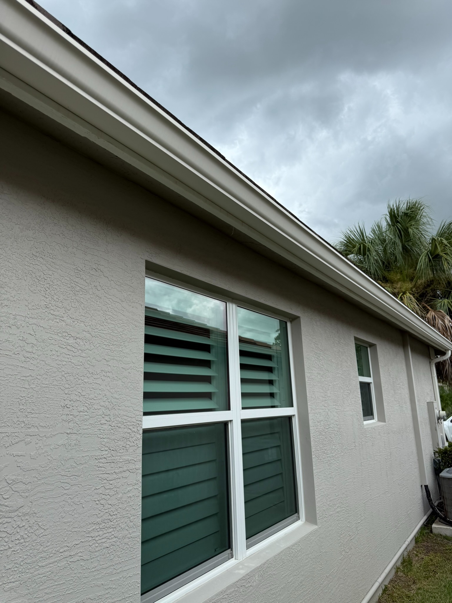 Gutter cleaning, side eave line in Tradition, FL — after